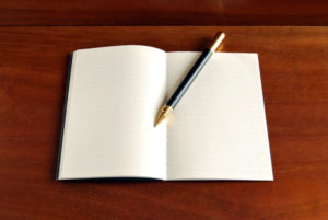 notebook blank page on warm wood background